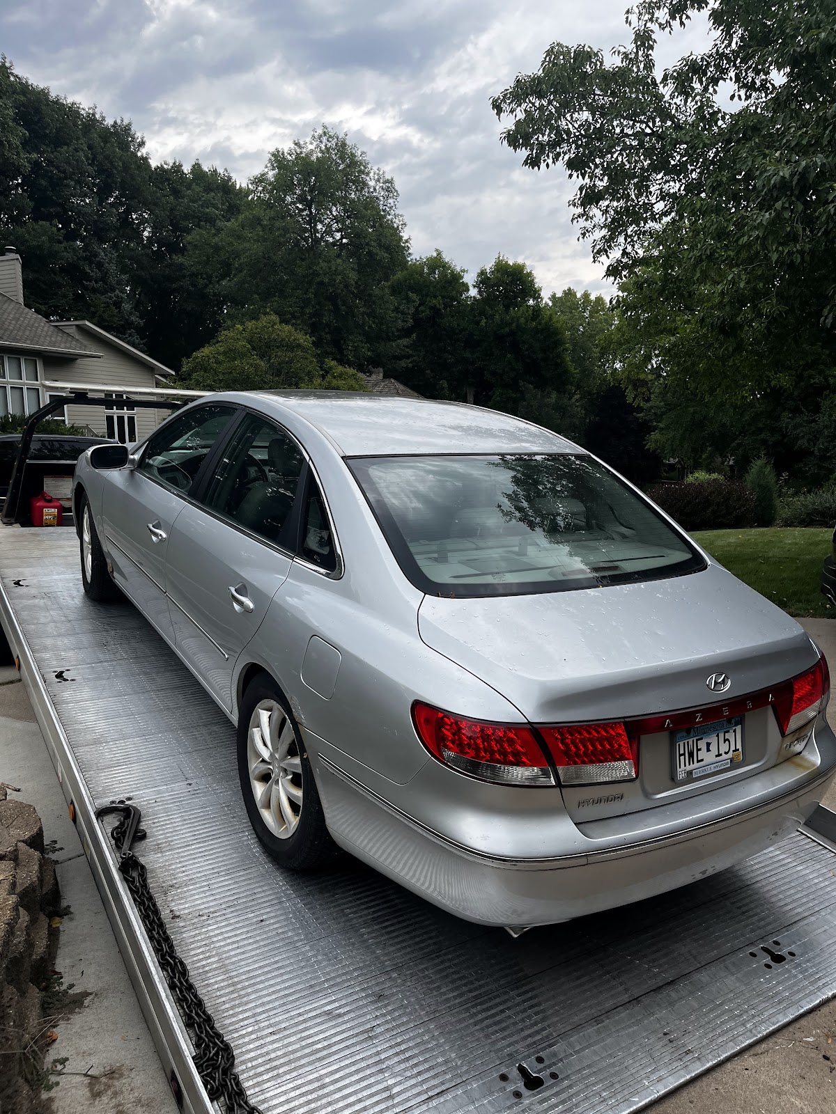 Broken-down sedan loaded on an AMG Towing LLC flatbed